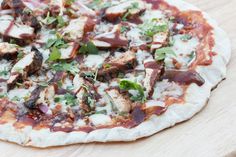 a pizza sitting on top of a wooden cutting board