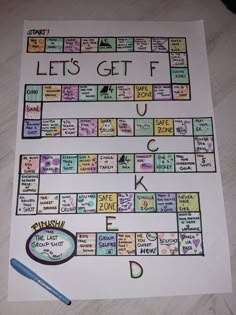 a game board with words and pictures on it, next to a marker that says let's get f