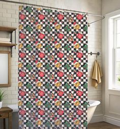 a bathroom with a checkered shower curtain that has smiley faces on it and is next to a bathtub