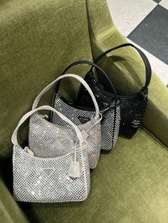 New for SS23. This light grey mini hobo bag, an iconic Prada style, comes in a luxurious satin version studded with crystals and decorated with the emblematic enamel triangle logo. All items are brand new & 100% authentic guaranteed. Supplied in its original packaging. DETAILSAll-over decoration (artificial crystals)Zipper closureEnameled metal triangle logoSilk satin lining17 cm Height6 cm Length22 cm WidthNeed assistance? Use our Sourcery service or speak to a member of our team via WhatsApp Grey Designer Bag, Sparkly Prada Bag, Prada Crystal Bag, Prada Bag Aesthetic, Prada Mini Bag, Sparkly Bag, Mini Hobo Bag, Prada Style, Rhinestone Bag