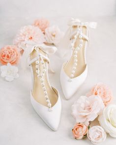 wedding shoes with pearls and flowers on the floor