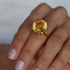 A lovely 10 carat oval citrine set in a wonderfully designed 18K yellow gold ring. The citrine is well cut has a great orangey color and is an immaculate looking stone.18K Yellow Gold Citrine 10tcw 16mm Band thickness 4.3mm Size 7.5 Resize available under request. Thank you for visiting our shop!Also, Follow us on Instagram https://www.instagram.com/dmkjewelryny/ Ring Settings For Oval Stones, Citrine Cocktail Ring, Yellow Stone Ring, Yellow Citrine Ring, Yellow Gold Cocktail Ring, Yellow Rings, Yellow Citrine, Citrine Ring, Oval Stone