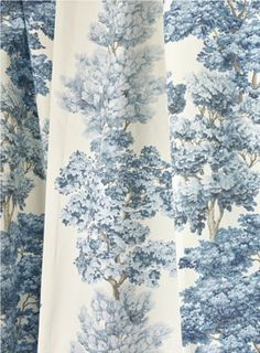 a blue and white curtain with trees on it