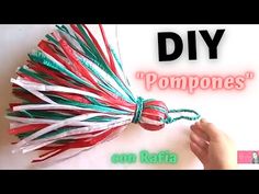 a hand holding a red, white and green pom - poms with the words diy on it