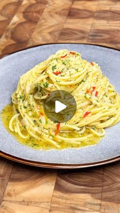 a plate full of pasta on a wooden table