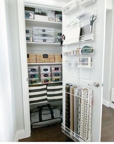 an organized closet with white shelves and drawers