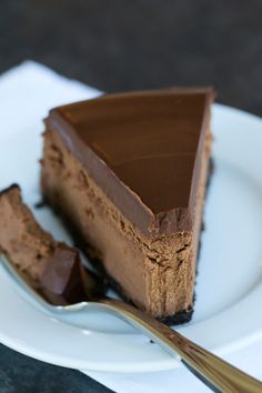 a piece of chocolate cheesecake on a plate with a fork