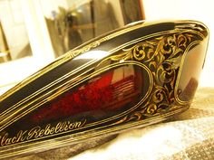 a close up of a red and black object on a table with a mirror in the background