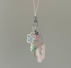 a necklace with beads and charms hanging from it