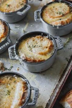 several baked dishes sitting on top of a baking sheet