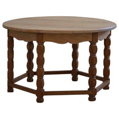 an oval wooden table with turned legs