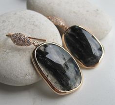 A statement pair of rose gold plated sterling silver black quartz dangle earrings featuring gorgeous streaks of black, accented with sparkly white crystal ear wire. Only one made, makes a one of a kind gift!  Wrapped in a Belesas branded box ready for gift giving.(E.sapphire.7)The lovely gemstone measure 30mm x 20mm*LIKE* us on Facebook http://www.facebook.com/Belesas to find special coupon codes,*FOLLOW* us on Twitter https://twitter.com/#!/Belesas to get more exclusive coupon codes*All item ar Earrings Sapphire, Rose Gold Earring, Elongated Oval, Earrings Stone, Black Quartz, Rectangle Earrings, Earrings Gemstone, Birthstone Earrings, Birthstone Earring