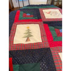 a quilted bedspread with christmas trees on it