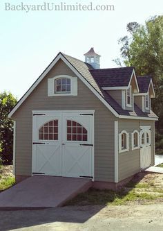 a two car garage with an attached porch