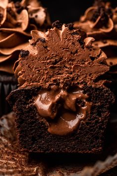 a chocolate cupcake with frosting on a plate