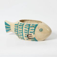 a ceramic fish shaped vase sitting on top of a table