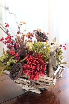 a basket filled with flowers on top of a wooden table