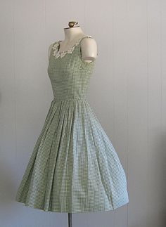 APPROXIMATE MEASUREMENTS (INCHES): Current Size: XS/S Bust: 34 Waist: 24 Hip: OPEN Bodice (shoulder to waist): 15 1/2 Skirt (waist to hem): 25 CONDITION Excellent DESCRIPTION 1950s sundress Fit & flare style Green and white cotton gingham fabric Back metal zip closure No tags; handmade Spring Retro Sleeveless Plaid Dress, Retro Sleeveless Plaid Dress For Spring, Vintage Sleeveless Spring Plaid Dress, Vintage Sleeveless Plaid Summer Dress, Vintage Sleeveless Plaid Dress, Vintage Plaid Sleeveless Dress, Vintage Sleeveless Plaid Cotton Dress, Vintage Gingham Dress For Garden Party, Fitted Sleeveless Vintage Plaid Dress