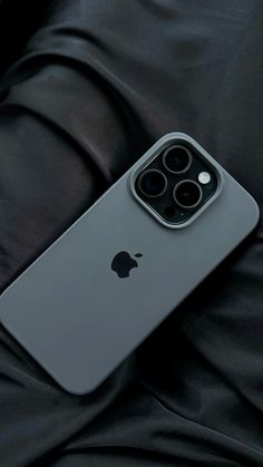 an iphone 11 pro sitting on top of a black cloth