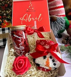 a gift box filled with candy and a snowman ornament