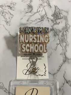 i can't imin nursing school pin badge on marble counter top with name tag