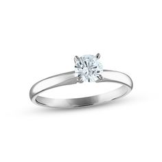 a white gold engagement ring with a single diamond