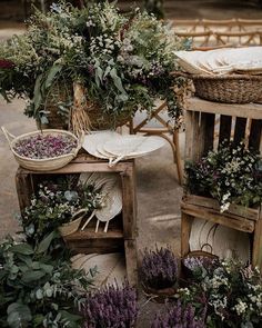 an arrangement of flowers and plants on wooden crates