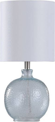 a clear glass table lamp with a white shade on the top and bottom part of it