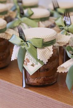 there are many small jars with food in them on the table and one has a fork