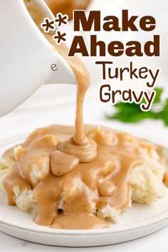 a white plate topped with mashed turkey and gravy covered in gravy