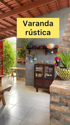 a patio with tables, chairs and potted plants on the outside wall that says veranda rustica