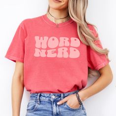 The Word Nerd english teach tee is a classic jersey short sleeve t-shirt that fits like a well-loved favorite. Perfect for active and leisure this t-shirt makes a great english teacher shirt or teacher appreciation gift. Soft cotton and quality print make you fall in love with it over and over again. .: Crew neckline .: Made with 100% US cotton that is ethically grown and harvested .: Medium weight fabric that is breathable and easy to layer .: Sustainable manufacturing .: Ribbed knit collar with seam .: Pre-shrunk ---------------------- SHIPPING INFO ---------------------- Shipping time for your order is approximately 2-5 business days. Once shipped you'll receive tracking information from Etsy. ---------------------- PROPER SIZING ---------------------- Please see photos to see a specifi Class Tshirt, Class Tshirts, English Teacher Shirt, English Teacher Gifts, Word Nerd, Sustainable Manufacturing, English Class, Gift Teacher, English Teacher