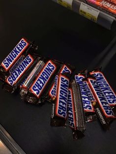 several bars of snickkers sitting on top of each other in front of some books