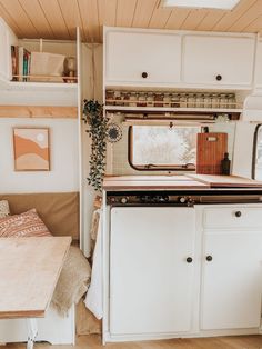 a kitchen area with a stove, sink and table in it's centerpiece