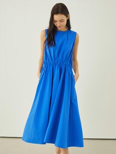 This lovely dress features voluminous, drapery silhouette in maxi length. It is accentuated with unique shirred details at waist.  - Intended for a loose fit- Lightweight cotton fabric- Airy, crisp texture- Casual side pockets and back zip fastenings- Cute and feminine feel Chic Dress With Gathered Waist And Voluminous Skirt, Spring Midi Dress With Pleated Waist And Voluminous Skirt, Cotton Maxi Dress With Pleated Bodice, Cotton Dress With Pleated Waist And Voluminous Skirt, Spring Dress With Voluminous Skirt And Gathered Waist, Cotton Maxi Dress With Gathered Waist For Daywear, Spring Dresses With Pleated Waist And Draped Shape, Cotton Ruched Maxi Dress, Ruched Cotton Maxi Dress