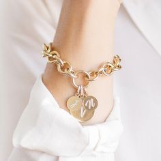 14K Yellow Round Link Charm Bracelet This Round Link Charm Bracelet is perfect for building your own heirloom bracelet. Order by itself or with charms that represent your special milestones and loved ones. Pairs perfectly with our Medium and Large Charms, as well as our Medallions! Pair with any of our loose charms and we will assemble them in-house for you! We recommend sizes medium or large, or get creative and choose one of our Falling Letter Pendants or Enamel Medallions. Product Details Link Size: 11.6 mm Weight: 7.5 inches (Solid Gold) is 9 grams (without any charms) Features a push in lock clasp Available in 14K Yellow Gold Not sure what size to order? Check out our Bracelet Sizing Guide! Comes in gift box Ships in 2 weeks (if ordered plain), 4 weeks if ordered with charms Additiona Elegant Charm Bracelet With Initials For Anniversary, Elegant Yellow Gold Charm Bracelet With Removable Charms, Elegant Initials Charm Bracelet For Anniversary, Yellow Gold Bangle Charm Bracelet For Anniversary, Customizable 14k Gold Bracelet Jewelry, Personalized 14k Gold Bracelets, Customizable 14k Gold Bracelet, Anniversary Yellow Gold Bangle Charm Bracelet, Personalized Oval Link Jewelry As A Gift