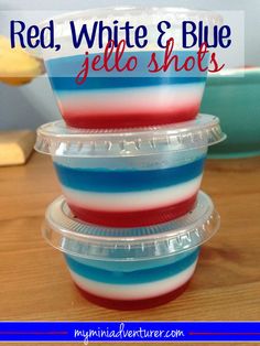 three red, white and blue jello shots in plastic containers on a wooden table