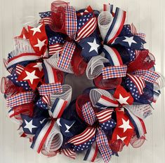 a patriotic wreath with red, white and blue bows