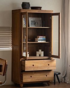 Reve Teak Bookcase with glass doors, shelves, and drawers displaying books and decor. Buffet Style, Double Glass Doors, Book Cabinet, Behind The Glass, Styling A Buffet, 3 Shelves, Large Shelves, Double Glass, Table Stool