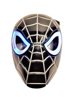 a spider man mask with glowing eyes on a white wall behind the mask is an evil looking face