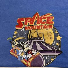 New Without Tags. Never Worn. Blue Tshirt With Mickey Space Mountain Design On The Front. Retro Style. Lightweight Soft Material Blue Disney T-shirt For Disney Trips, Themed Blue T-shirt For Fan Merchandise, Disney Graphic Print T-shirt For Disney Trips, Disney Trips Graphic Print Crew Neck T-shirt, Disney T-shirt With Cartoon Print For Disney Trips, Blue Graphic T-shirt For Disney Trips, Fun Crew Neck T-shirt For Disney Trips, Blue Graphic Print T-shirt For Disney Fan Events, Blue Graphic Tee For Disney Fan Events