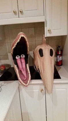 two fake toothbrushes in the shape of mouths on a kitchen counter