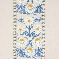 a blue and yellow floral design on a white linen material with an embroidered border in the center