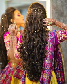 two women with long hair are looking at each other