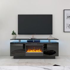 an entertainment center with a fireplace in the middle and a flat screen tv above it