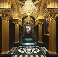 an ornate hallway with gold and black decor