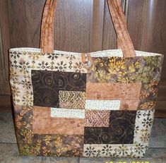 "Looking for a great gift or treat yourself to this quilted tote bag / purse.  Lovely batik fabric in shades of copper, bronze, cream and brown.   Convenient size of 16\" wide x 12\" tall x 3\" wide base. Button closure at the top,  along with four pockets inside.  Perfect for cell phone, pens, personal items.  Machine washable in cool water.  Hang to dry. If you are looking for a custom bag in your choice of colors, contact me today! Made in a pet-free and smoke free studio." Trendy Quilted Brown Bag, Casual Quilted Tote Shoulder Bag, Brown Quilted Tote Bag, Brown Quilted Rectangular Bag, Casual Brown Patchwork Bag, Brown Rectangular Patchwork Bag, Quilted Tote Bags, Quilted Totes, Tote Bag Purse