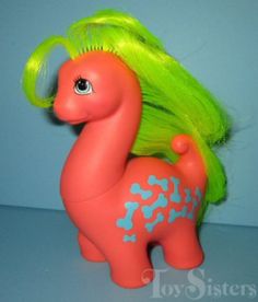 a toy pony with bright green hair on it's head