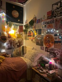 a bed room with a neatly made bed and lots of pictures on the wall above it