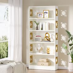 a white bookcase with gold decorations in a bedroom